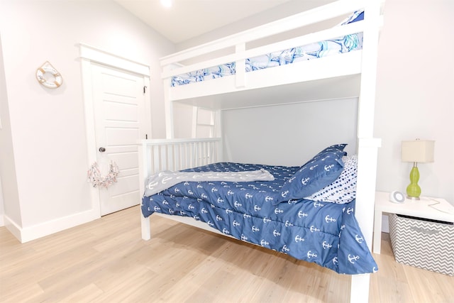 bedroom featuring baseboards and wood finished floors