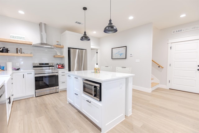 kitchen with open shelves, light wood finished floors, appliances with stainless steel finishes, wall chimney range hood, and decorative backsplash