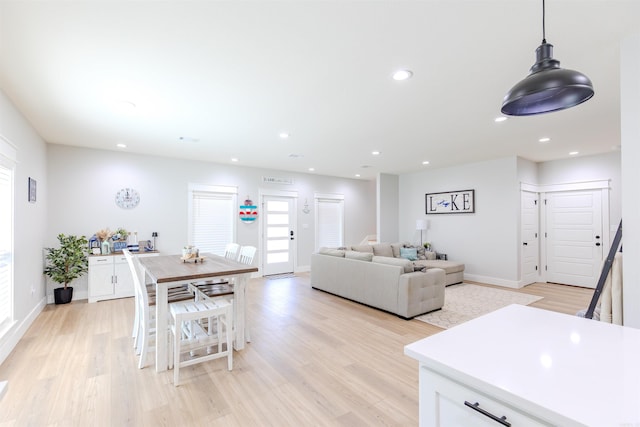 dining area featuring baseboards, light wood-style floors, and recessed lighting