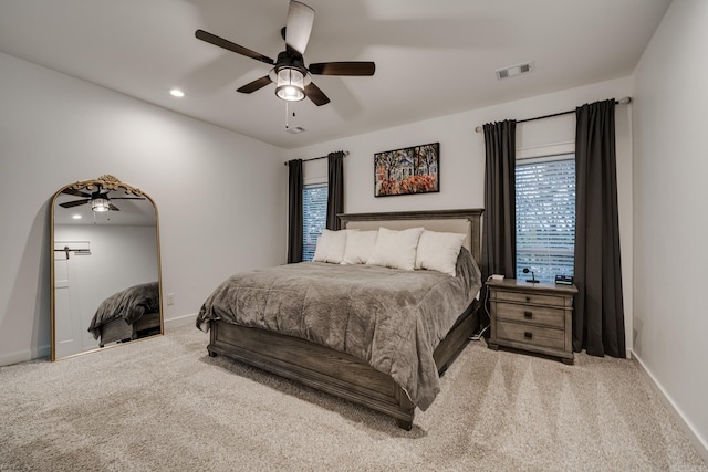 carpeted bedroom featuring baseboards, visible vents, recessed lighting, and a ceiling fan