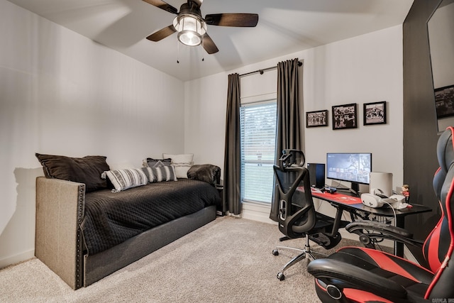 carpeted home office featuring ceiling fan