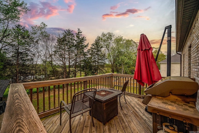 wooden terrace featuring an outdoor fire pit