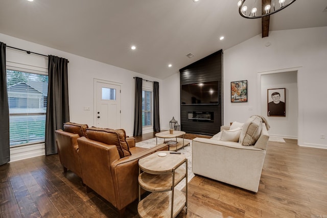 living room featuring wood finished floors, baseboards, beamed ceiling, recessed lighting, and an inviting chandelier