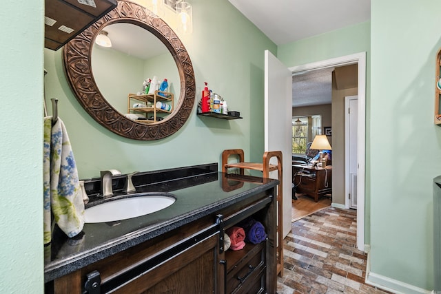 3613 Northlake Rd, Alexander, AR 72002 - bathroom with baseboards, brick floor, visible vents, and vanity
