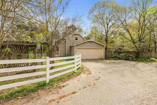 3613 Northlake Rd, Alexander, AR 72002 - exterior space with a fenced front yard, dirt driveway, and a garage