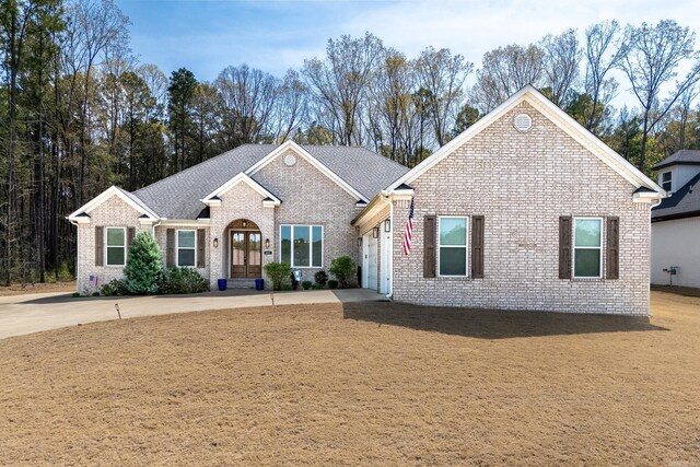 411 Sienna Lake Dr, Little Rock, AR 72210 - ranch-style home with a garage, concrete driveway, brick siding, a shingled roof, and french doors