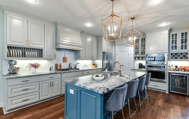 411 Sienna Lake Dr, Little Rock, AR 72210 - kitchen featuring wine cooler, stainless steel appliances, dark wood-type flooring, and a notable chandelier