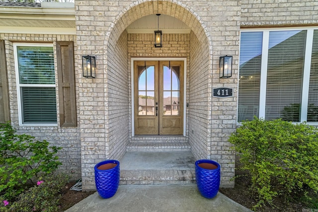411 Sienna Lake Dr, Little Rock, AR 72210 - view of exterior entry with stone siding, brick siding, and french doors