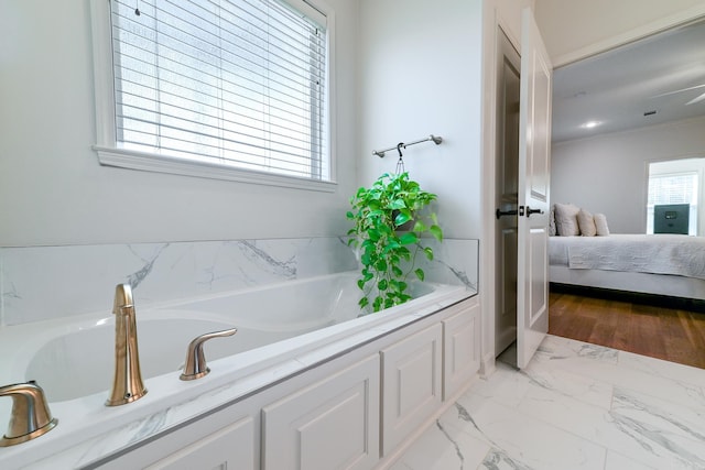 411 Sienna Lake Dr, Little Rock, AR 72210 - ensuite bathroom featuring marble finish floor, ornamental molding, ensuite bathroom, and a garden tub