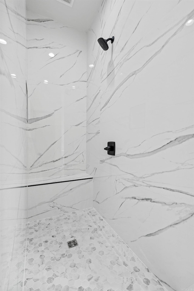 bathroom with a marble finish shower