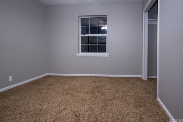 unfurnished bedroom featuring baseboards, a closet, and carpet flooring