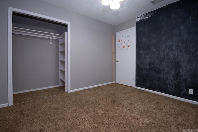 unfurnished bedroom featuring baseboards, carpet floors, and visible vents