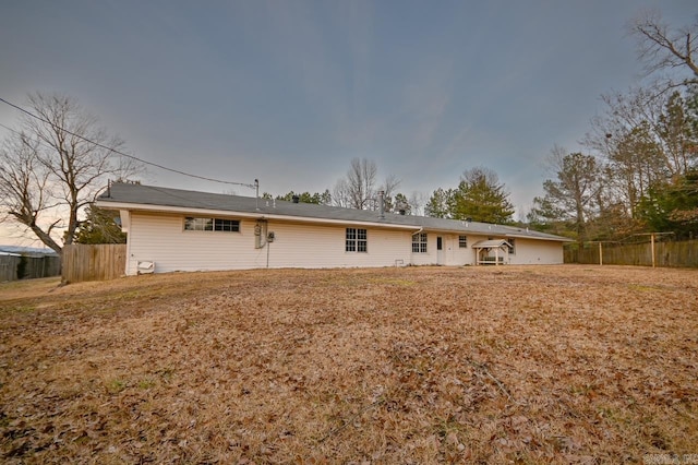 back of property featuring fence