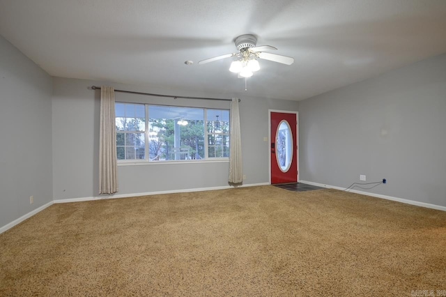 interior space with baseboards, carpet floors, and a ceiling fan