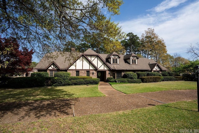 1110 Huntington Pl, Heber Springs, AR 72543 - english style home with a front yard and a shingled roof