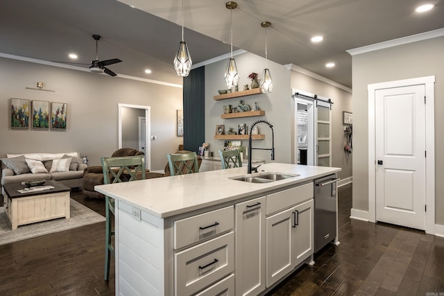 kitchen with recessed lighting, dark wood finished floors, a sink, a barn door, and a ceiling fan