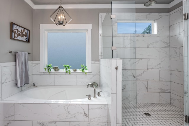 full bath featuring a bath, a stall shower, and a notable chandelier