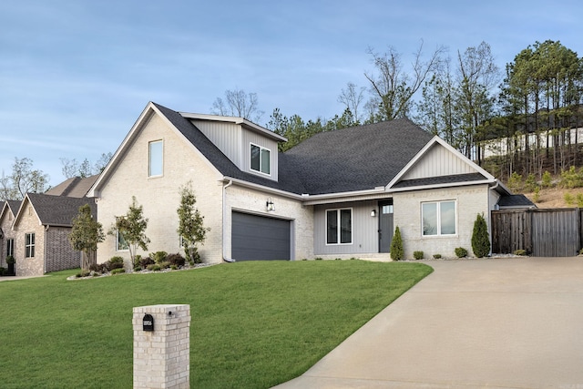 view of front facade featuring brick siding, a shingled roof, a front lawn, and concrete driveway