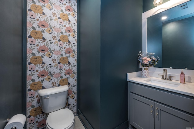 bathroom featuring toilet and vanity