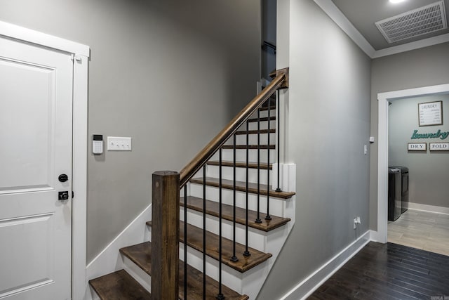 stairway with wood finished floors, baseboards, and visible vents