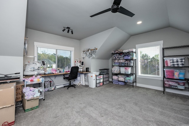 carpeted office space with a ceiling fan, a healthy amount of sunlight, baseboards, and lofted ceiling