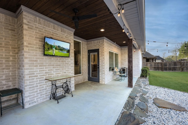 view of patio with ceiling fan and fence