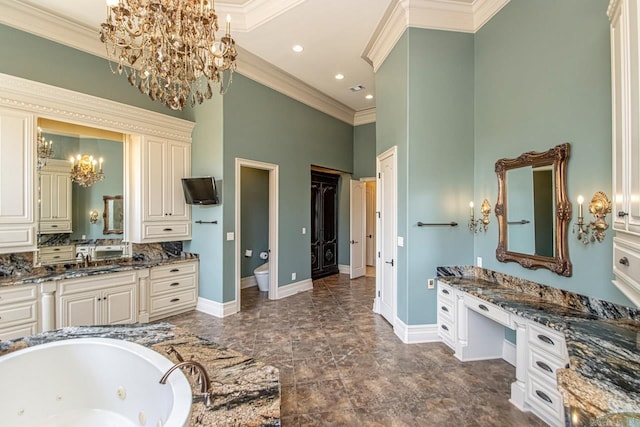 full bath with an inviting chandelier, a sink, crown molding, and baseboards