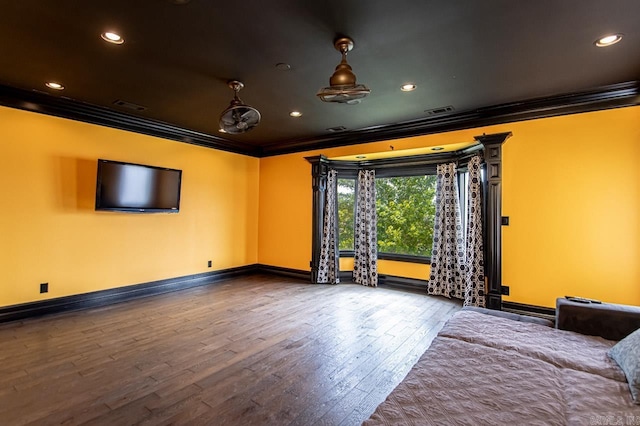 interior space featuring baseboards, visible vents, ornamental molding, and wood finished floors