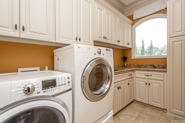 clothes washing area featuring light tile patterned floors, cabinet space, ornamental molding, and washer and dryer