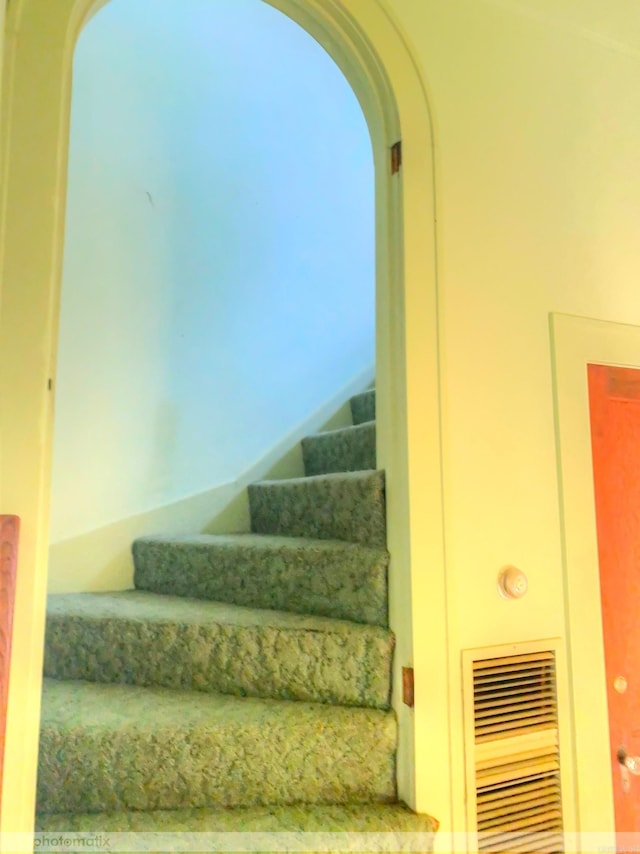 stairs featuring arched walkways and visible vents