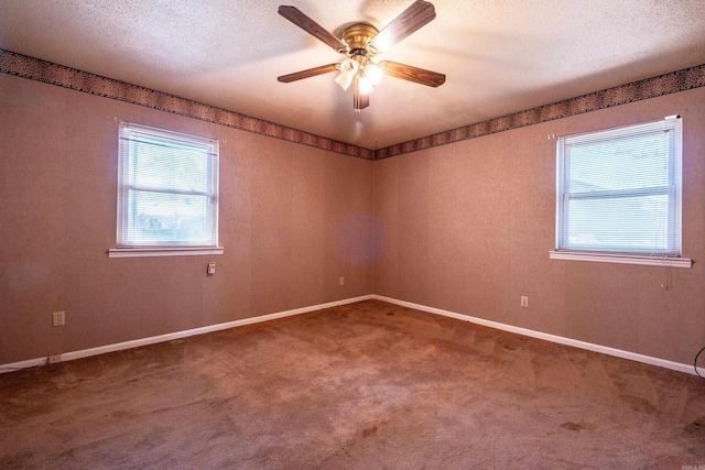 empty room featuring baseboards, a textured ceiling, ceiling fan, and carpet