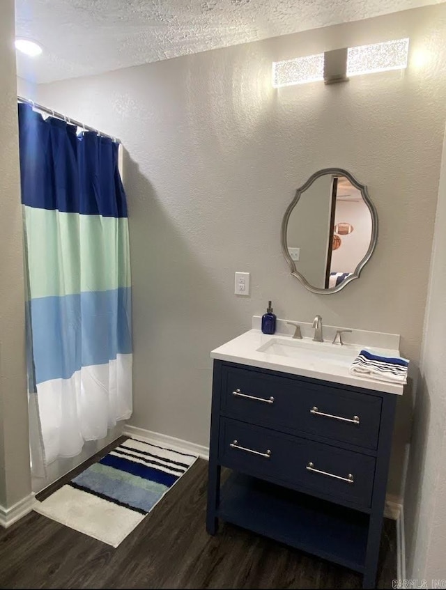 6 Timber Ridge Dr, Atlanta, TX 75551 - full bathroom featuring a shower with curtain, vanity, baseboards, and wood finished floors