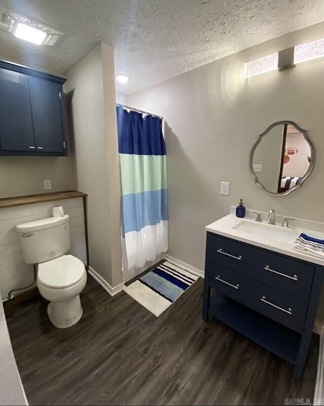 6 Timber Ridge Dr, Atlanta, TX 75551 - bathroom with toilet, vanity, a textured ceiling, and wood finished floors
