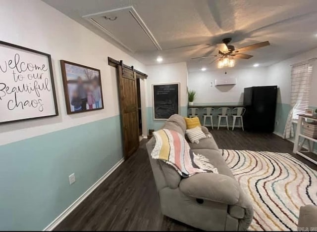 6 Timber Ridge Dr, Atlanta, TX 75551 - living room featuring attic access, baseboards, a barn door, ceiling fan, and wood finished floors