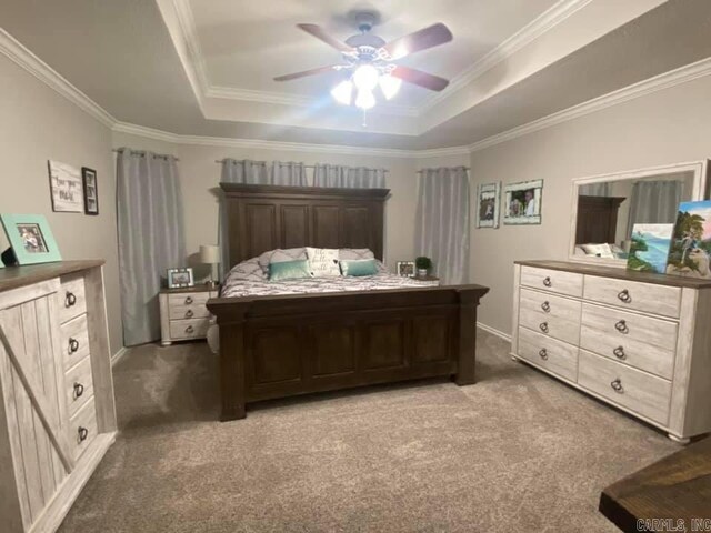 6 Timber Ridge Dr, Atlanta, TX 75551 - carpeted bedroom featuring a tray ceiling, ornamental molding, and a ceiling fan