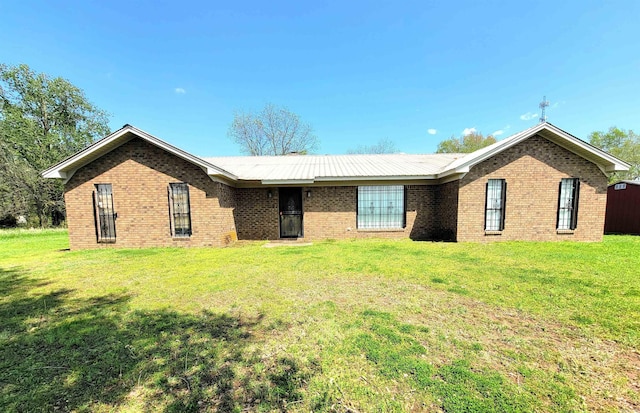 ranch-style home with a front lawn and brick siding