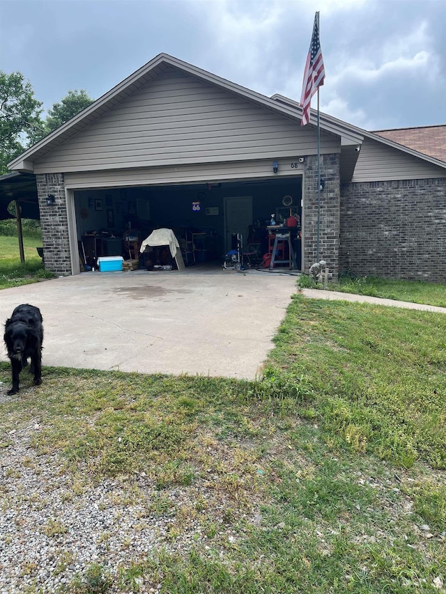 68 Kinder Loop, Russellville, AR 72802 - view of side of property with driveway, brick siding, and an attached garage