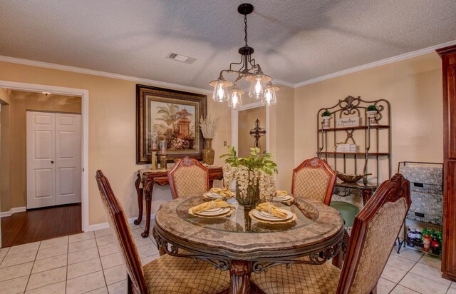 7200 Nell Dr, Pine Bluff, AR 71603 - dining room with visible vents, a notable chandelier, ornamental molding, and light tile patterned floors