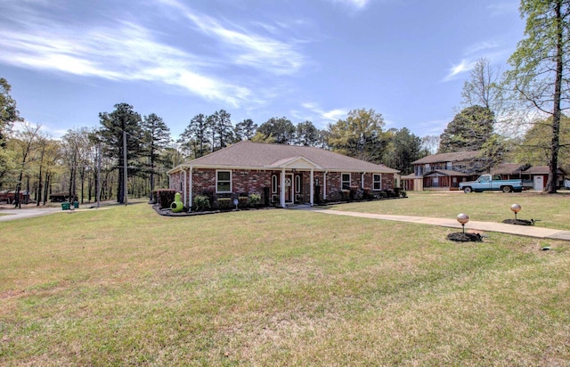 7200 Nell Dr, Pine Bluff, AR 71603 - ranch-style house featuring a front yard and brick siding
