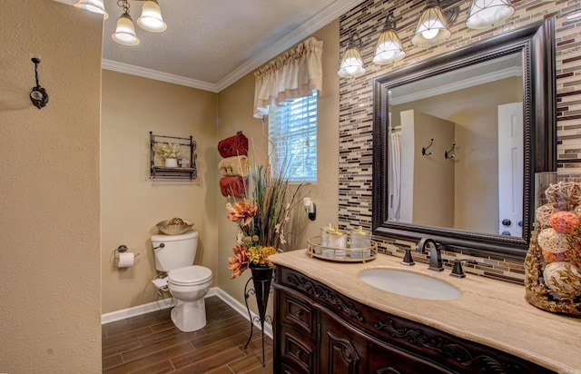 7200 Nell Dr, Pine Bluff, AR 71603 - full bathroom with crown molding, toilet, vanity, wood finish floors, and baseboards