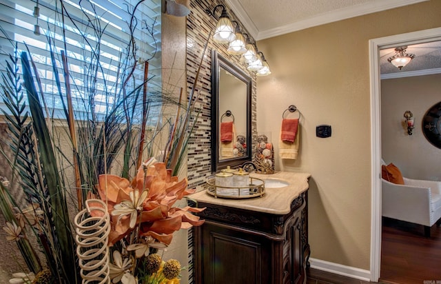 7200 Nell Dr, Pine Bluff, AR 71603 - bathroom featuring vanity, wood finished floors, a textured ceiling, baseboards, and ornamental molding