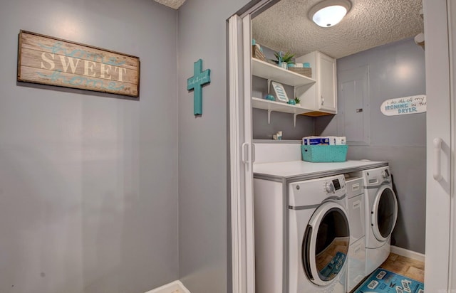 7200 Nell Dr, Pine Bluff, AR 71603 - washroom featuring baseboards, washing machine and clothes dryer, cabinet space, and a textured ceiling