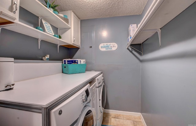 7200 Nell Dr, Pine Bluff, AR 71603 - laundry room featuring cabinet space, baseboards, washer and dryer, and a textured ceiling