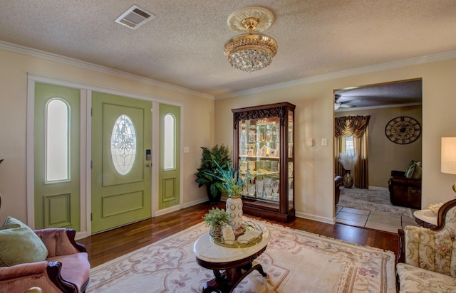 7200 Nell Dr, Pine Bluff, AR 71603 - entryway featuring wood finished floors, a wealth of natural light, a textured ceiling, and visible vents