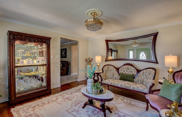 7200 Nell Dr, Pine Bluff, AR 71603 - living room with a textured ceiling, crown molding, wood finished floors, and a chandelier