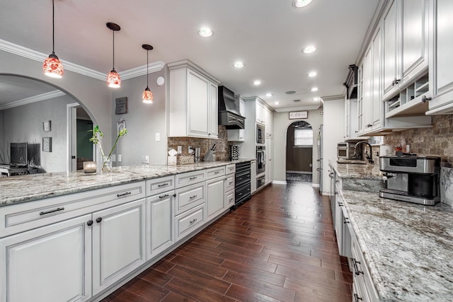 168 Leta Ln, Hot Springs, AR 71913 - kitchen with recessed lighting, premium range hood, dark wood finished floors, arched walkways, and white cabinetry