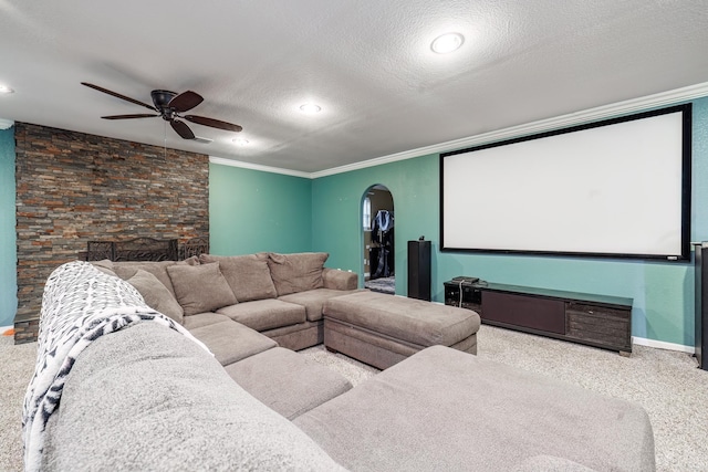 168 Leta Ln, Hot Springs, AR 71913 - carpeted home theater room with a textured ceiling, crown molding, baseboards, a ceiling fan, and arched walkways