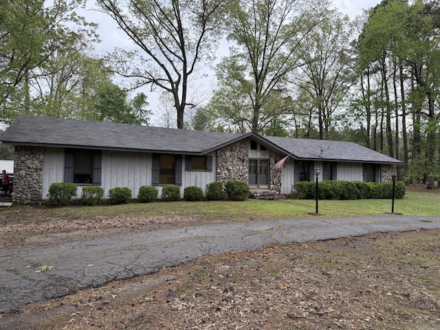 view of front of house featuring a front yard and stone siding
