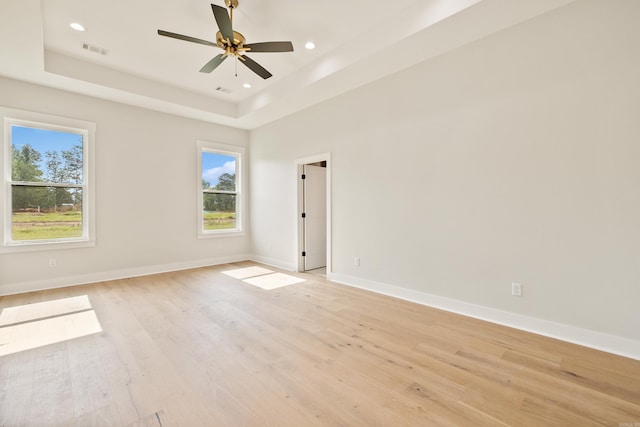 6172 Majestic Waters Dr, Alexander, AR 72002 - empty room with a raised ceiling, light wood-style floors, baseboards, recessed lighting, and a ceiling fan