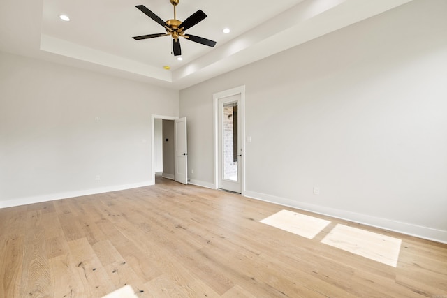 6172 Majestic Waters Dr, Alexander, AR 72002 - empty room featuring recessed lighting, baseboards, light wood finished floors, and a tray ceiling